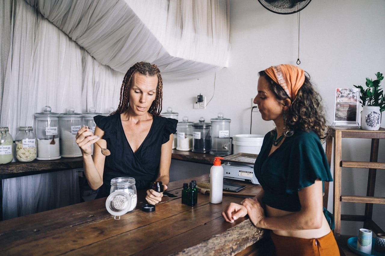 Women interacting at an eco-friendly shop discussing reusable containers.